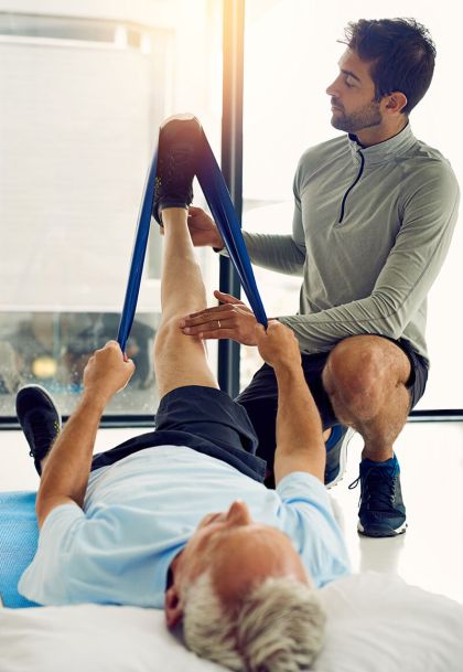 Personal trainer working on left of client - Athletic Therapy