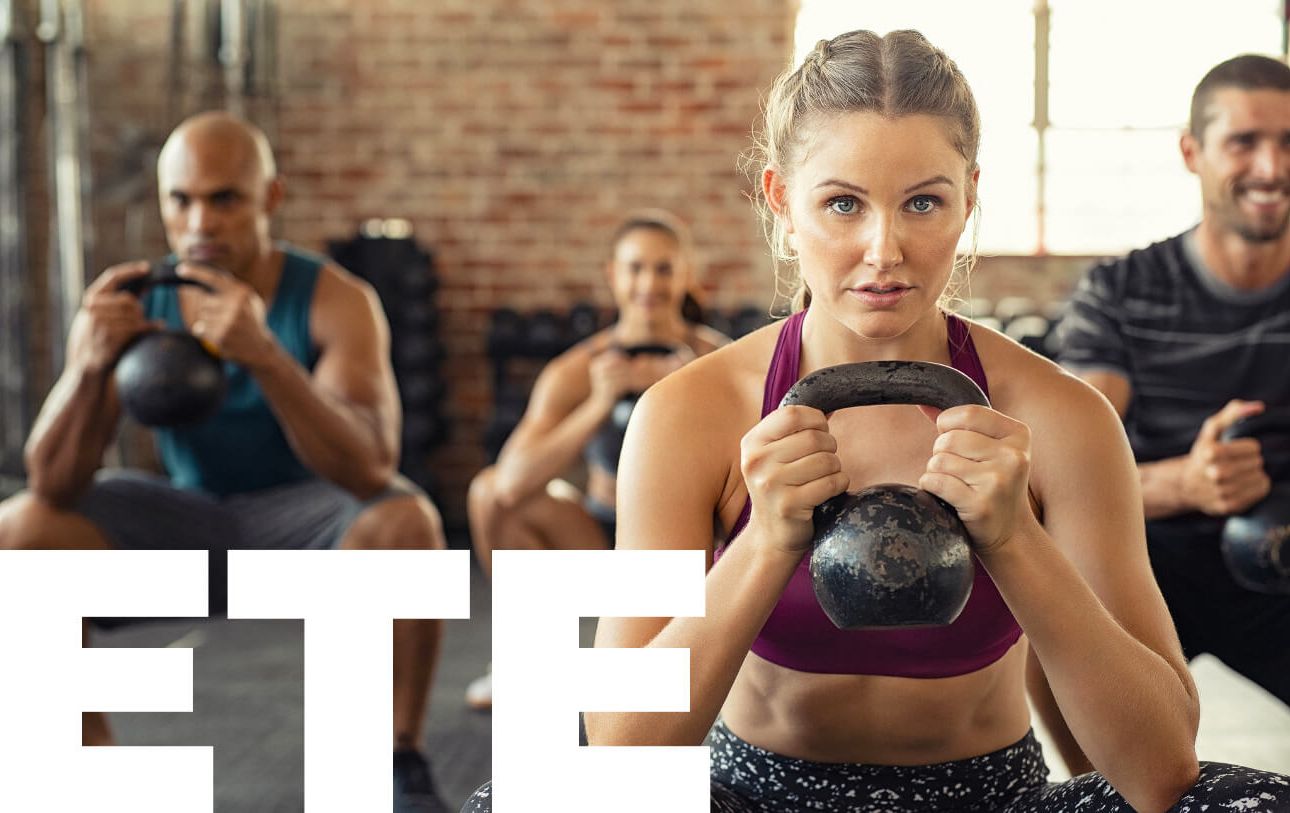 Clients working in gym with kettle-ball - Strength & Conditioning