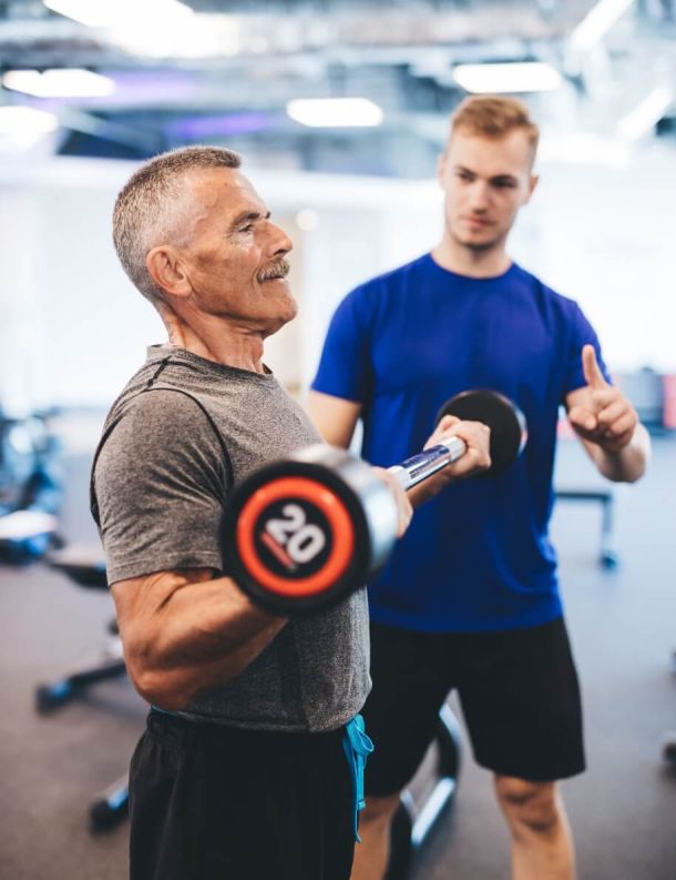 Personal trainer working with client at gym