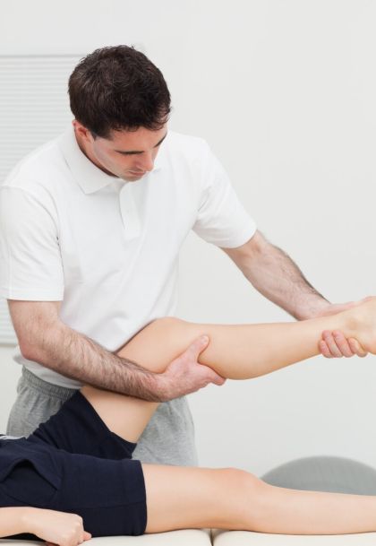 Personal trainer working on client's leg - Upstream Athletics