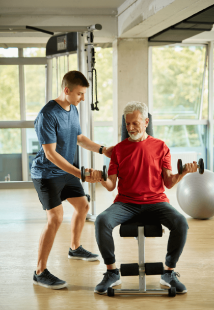 Personal trainer working with client at gym